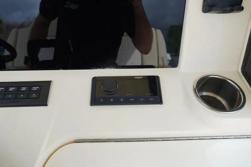 Slide: The Image of 2026 Scout 288 LXF boat dashboard with Fusion audio system and cup holder. - 25