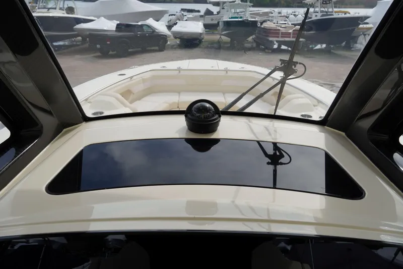 Slide: The Image of 2026 Scout 288 LXF boat dashboard view with compass and windshield wipers. - 27