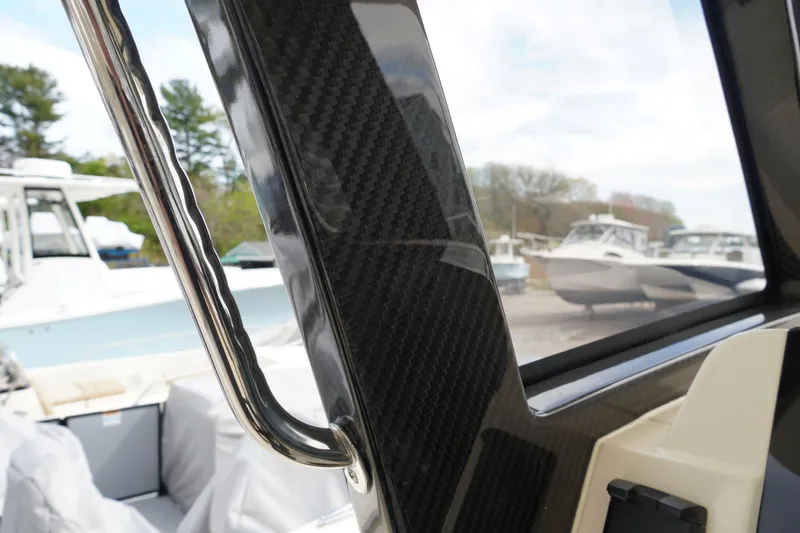 Slide: The Image of 2026 Scout 288 LXF boat interior with carbon fiber detailing and stainless steel handle. - 29