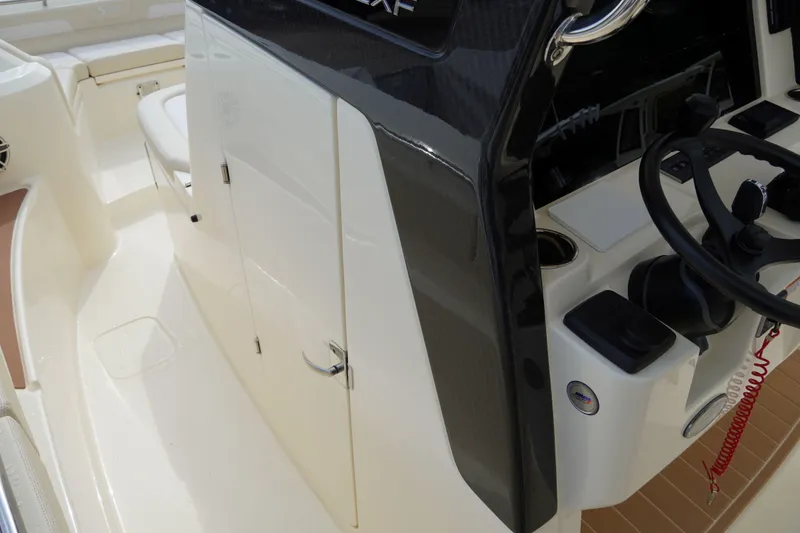 Slide: The Image of 2026 Scout 288 LXF boat interior with steering wheel and control panel. - 30