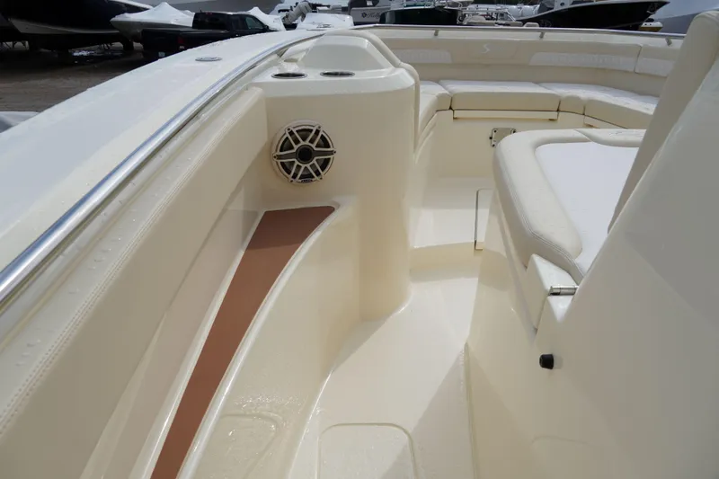 Slide: The Image of 2026 Scout 288 LXF boat interior with seating and speaker detail. - 35