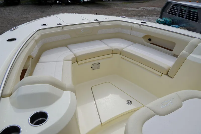 Slide: The Image of Luxurious seating area on a 2026 Scout 288 LXF boat, featuring comfortable cushions and cup holders. - 36