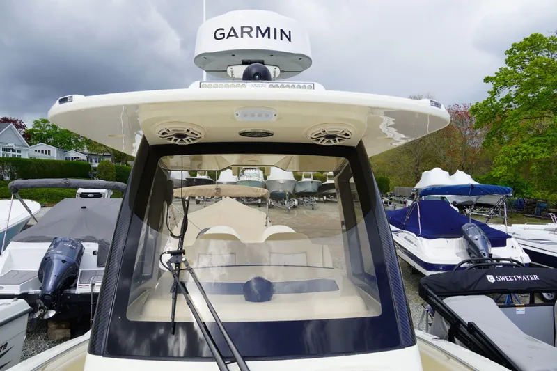 Slide: The Image of 2026 Scout 288 LXF boat with Garmin equipment, docked among other boats. - 45