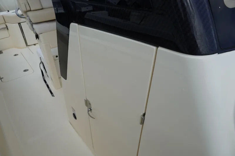 Slide: The Image of 2026 Scout 288 LXF boat interior, featuring sleek white cabinetry and seating. - 48