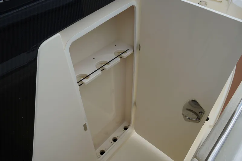 Slide: The Image of Open storage compartment on 2026 Scout 288 LXF boat, featuring sleek design and secure latch. - 49