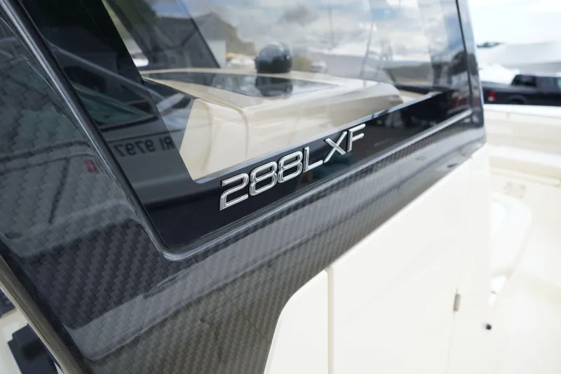 Slide: The Image of 2026 Scout 288 LXF boat with sleek carbon fiber detailing. - 50