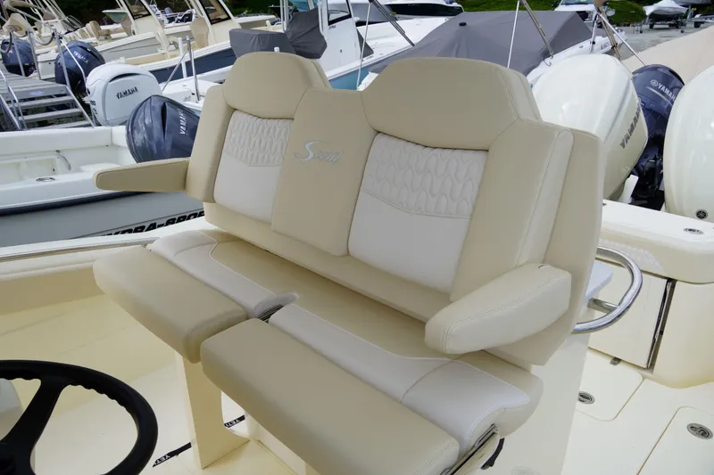 Slide: The Image of 2026 Scout 288 LXF boat with luxurious beige seating and steering wheel. - 52