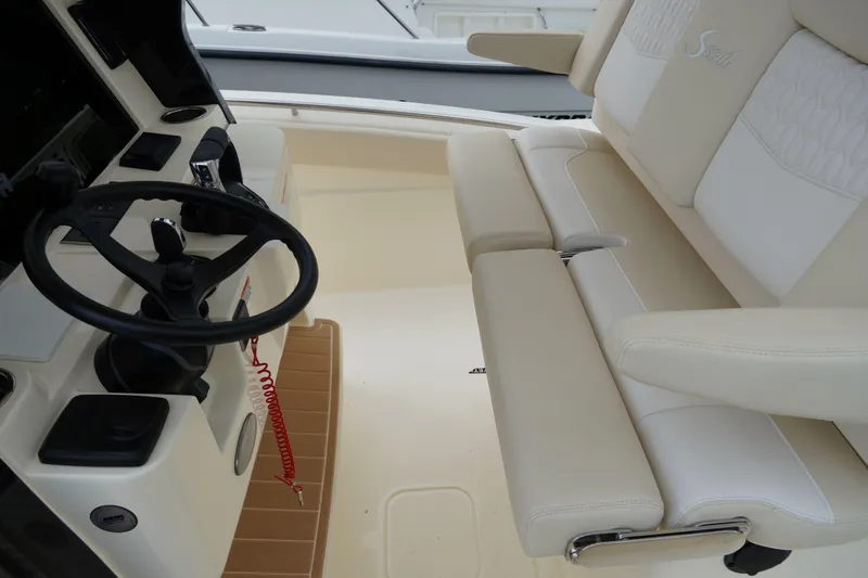 Slide: The Image of Helm and seating area of 2026 Scout 288 LXF boat, featuring modern controls and plush seating. - 53