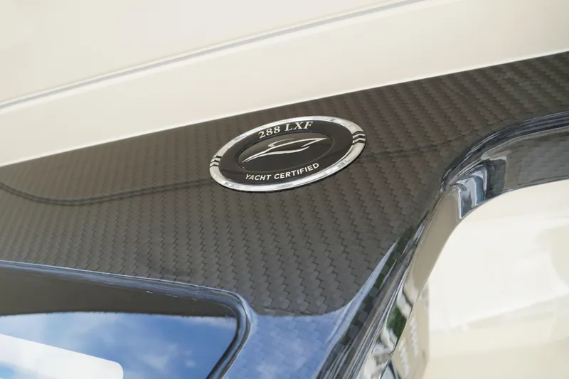 Slide: The Image of 2026 Scout 288 LXF yacht certified emblem on carbon fiber surface. - 55