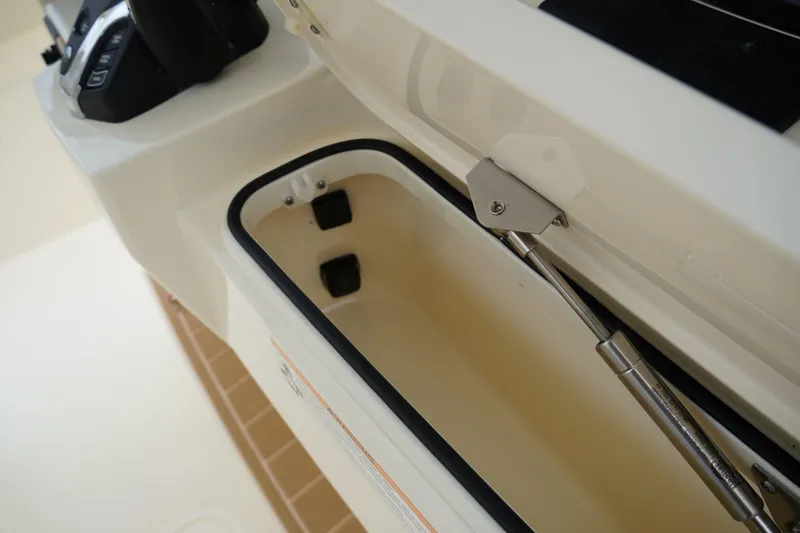 Slide: The Image of Storage compartment of 2026 Scout 288 LXF boat, featuring hydraulic lift support. - 57