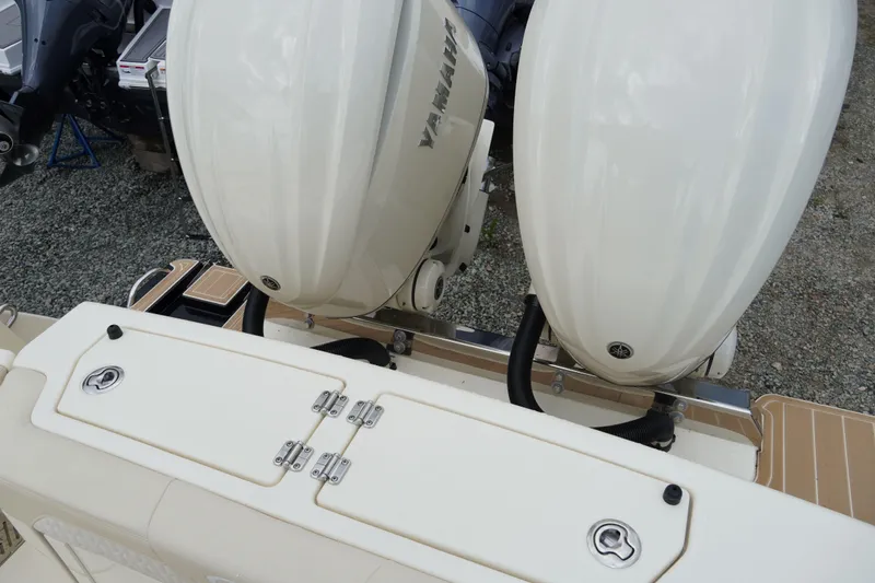 Slide: The Image of 2026 Scout 288 LXF boat with dual Yamaha outboard engines, rear view. - 58