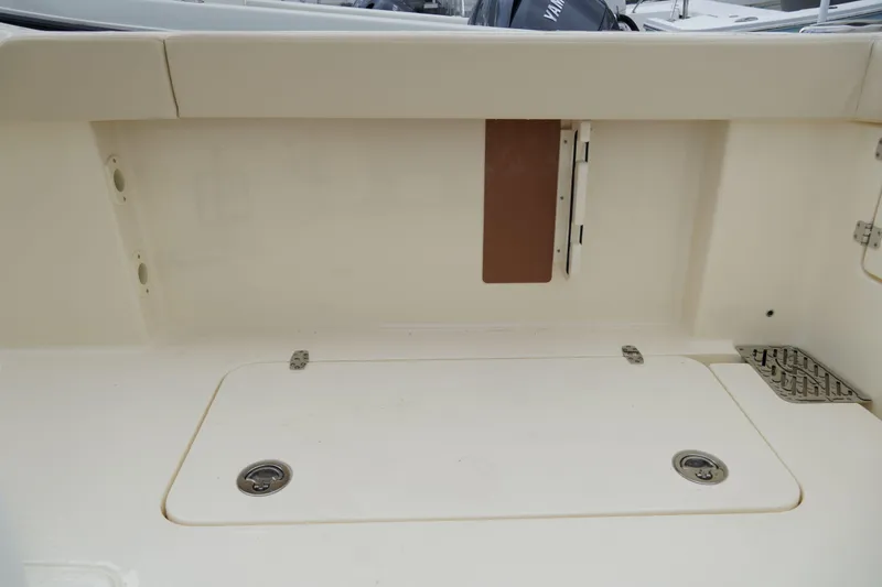 Slide: The Image of 2026 Scout 288 LXF boat interior, featuring a clean, spacious storage compartment. - 60