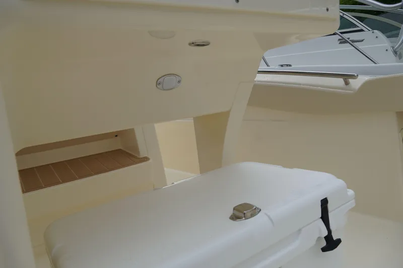 Slide: The Image of 2026 Scout 288 LXF boat interior with storage compartment and cooler. - 61