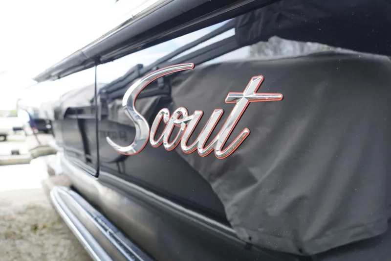 Slide: The Image of 2026 Scout 288 LXF boat logo on sleek black surface. - 66