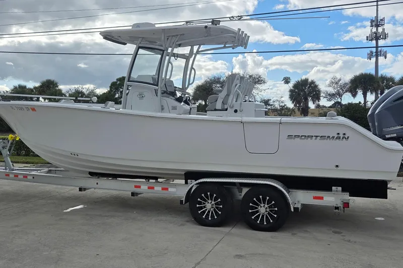 The Image of 2020 Sportsman Open 282 Center Console boat on trailer, parked outdoors. - 0