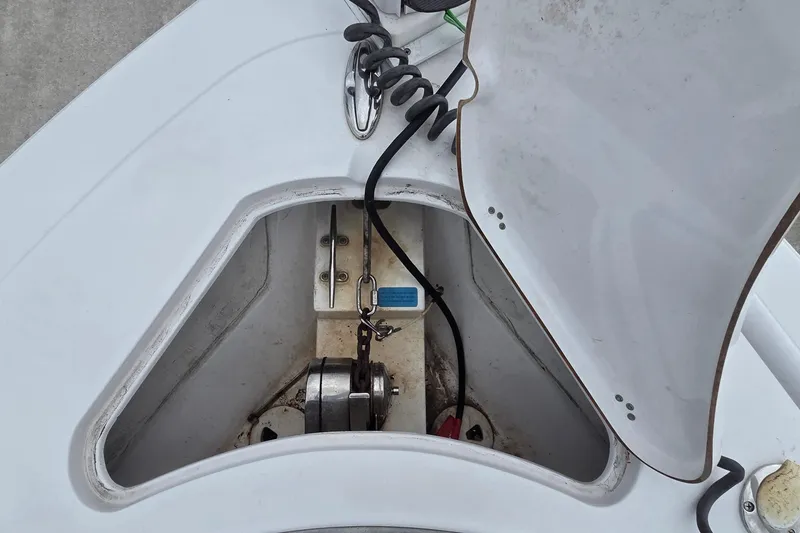 Slide: The Image of 2020 Sportsman Open 282 Center Console anchor locker with open hatch and visible winch. - 11