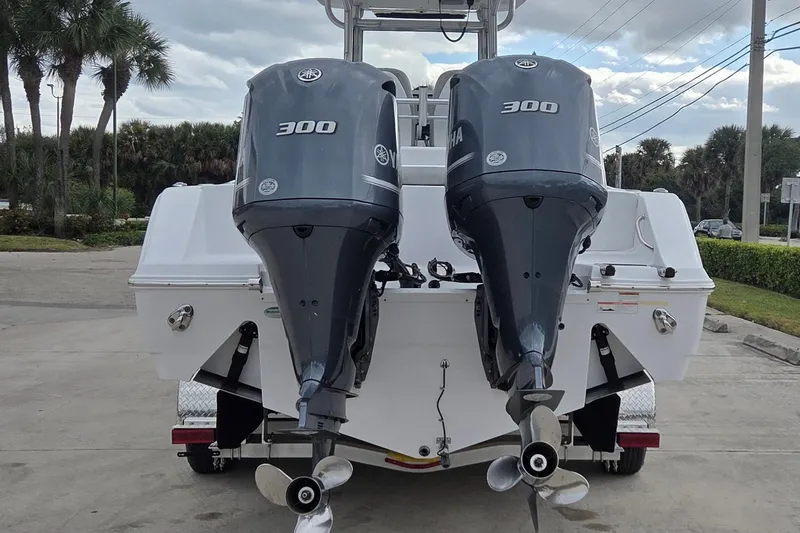 Slide: The Image of 2020 Sportsman Open 282 Center Console with dual Yamaha 300 engines, parked outdoors. - 3