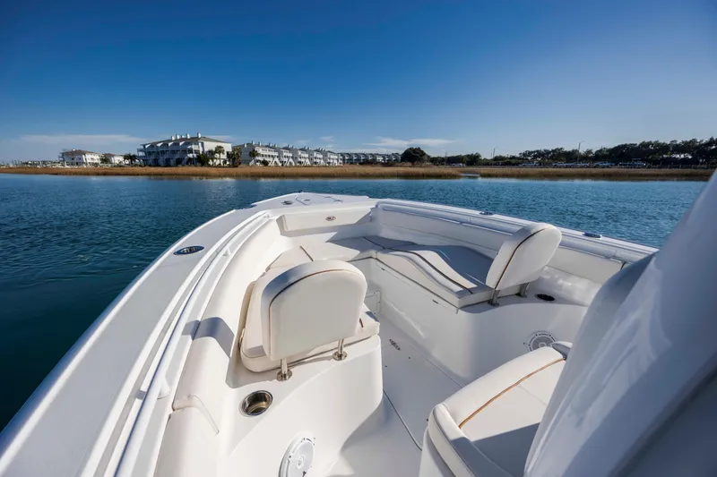 Slide: The Image of 2022 Sea Hunt Ultra 265 SE boat interior with waterfront view. - 13