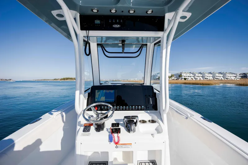 Slide: The Image of 2022 Sea Hunt Ultra 265 SE boat dashboard with scenic water view. - 16