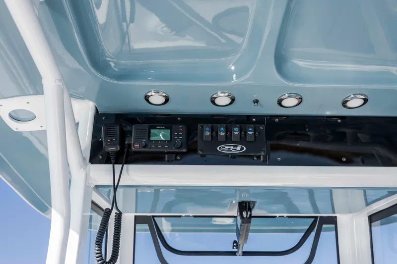 Slide: The Image of 2022 Sea Hunt Ultra 265 SE boat console with radio and controls. - 18