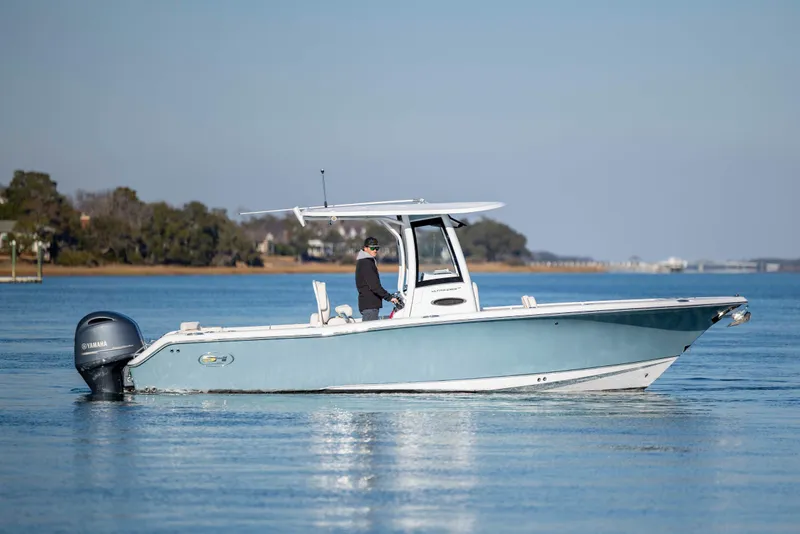 Slide: The Image of 2022 Sea Hunt Ultra 265 SE boat on calm water with Yamaha engine. - 2
