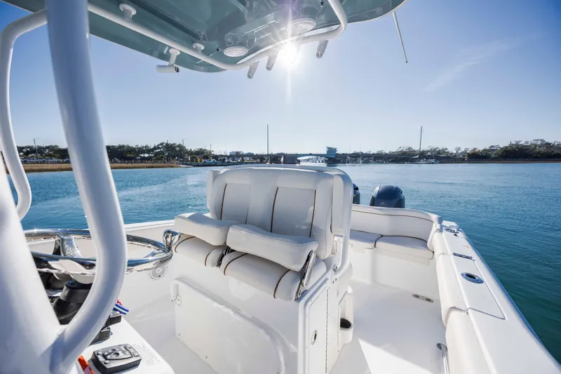 Slide: The Image of 2022 Sea Hunt Ultra 265 SE boat interior with seating, on a sunny day. - 20