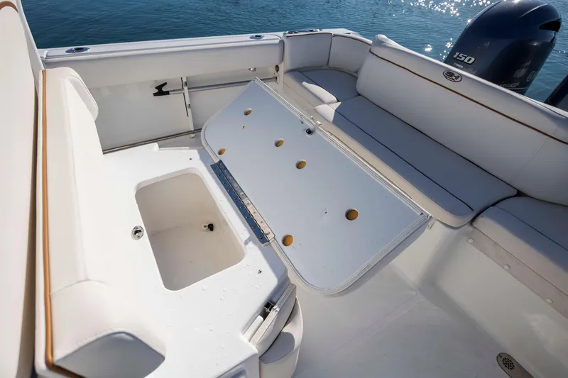 Slide: The Image of 2022 Sea Hunt Ultra 265 SE boat interior with seating and storage compartments. - 22