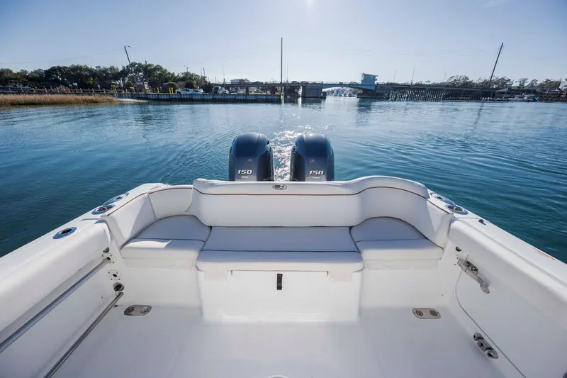 Slide: The Image of 2022 Sea Hunt Ultra 265 SE boat with dual engines on calm water. - 27
