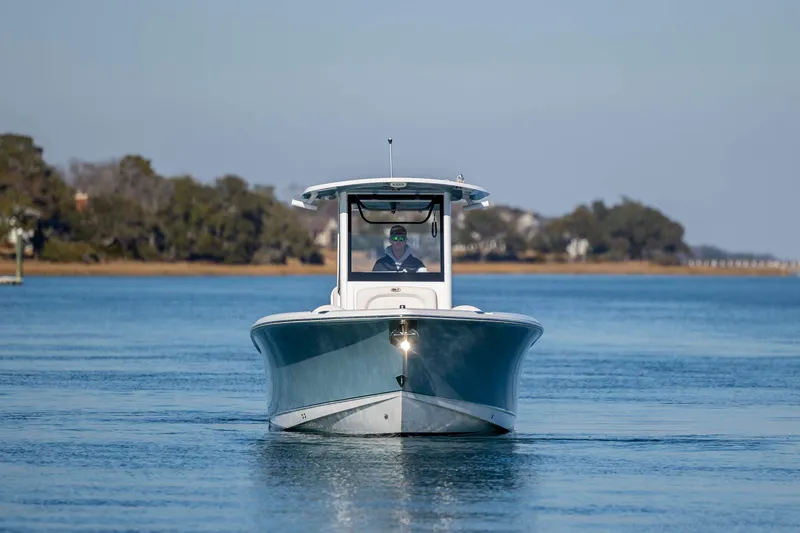 Slide: The Image of 2022 Sea Hunt Ultra 265 SE boat cruising on calm water. - 5