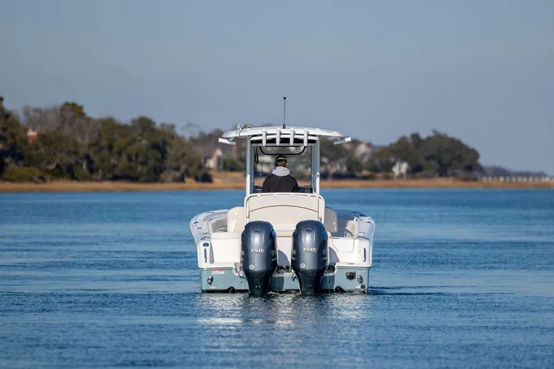 Slide: The Image of 2022 Sea Hunt Ultra 265 SE boat cruising on calm water. - 9