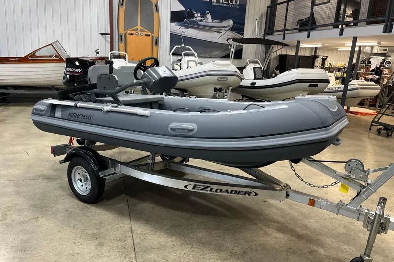 The Image of 2026 Highfield Classic 360 FCT inflatable boat on trailer in showroom. - 0