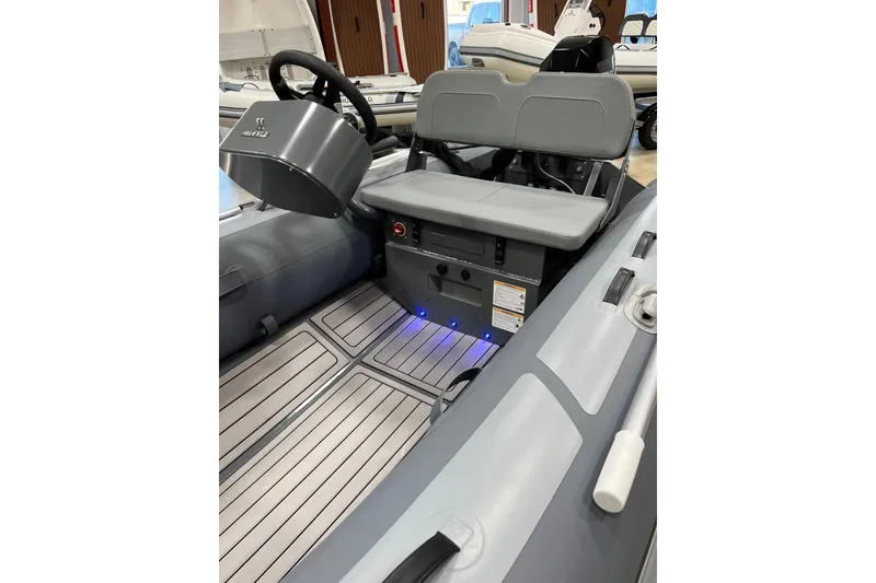 Slide: The Image of 2026 Highfield Classic 360 FCT boat interior with steering console and seating. - 4