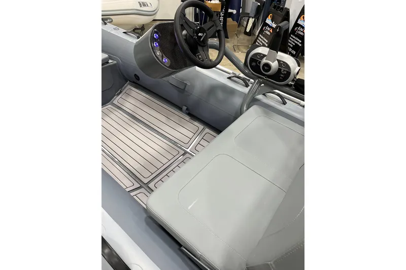 Slide: The Image of Interior of 2026 Highfield Classic 360 FCT boat with steering wheel and seating. - 5