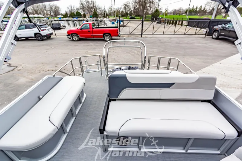 Slide: The Image of 2026 Godfrey Sweetwater 2286 SFLC pontoon boat interior with seating, docked at marina. - 15