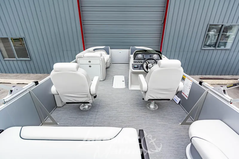 Slide: The Image of 2026 Godfrey Sweetwater 2286 SFLC pontoon boat interior with white seating and modern dashboard. - 25
