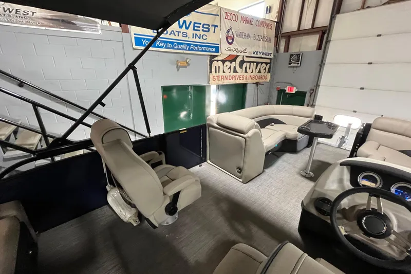 Slide: The Image of 2021 Barletta Cabrio 20UC pontoon boat interior with plush seating and modern dashboard. - 13