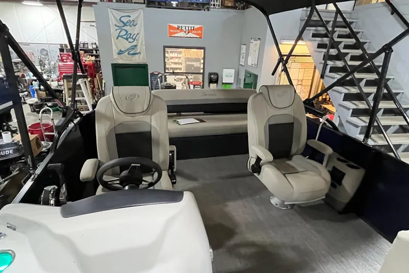Slide: The Image of 2021 Barletta Cabrio 20UC interior with seating and steering wheel in a showroom. - 16