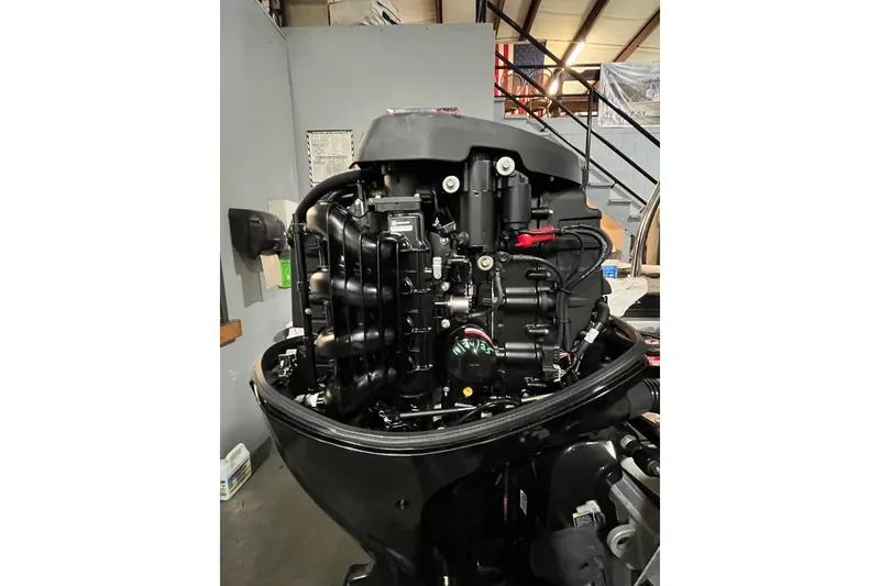 Slide: The Image of 2021 Barletta Cabrio 20UC boat engine in a workshop setting. - 7