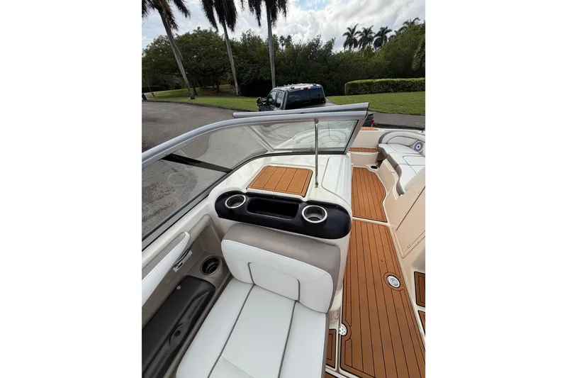 Slide: The Image of 2014 Yamaha Boats 242 Limited interior with white seating and wood-style flooring. - 17