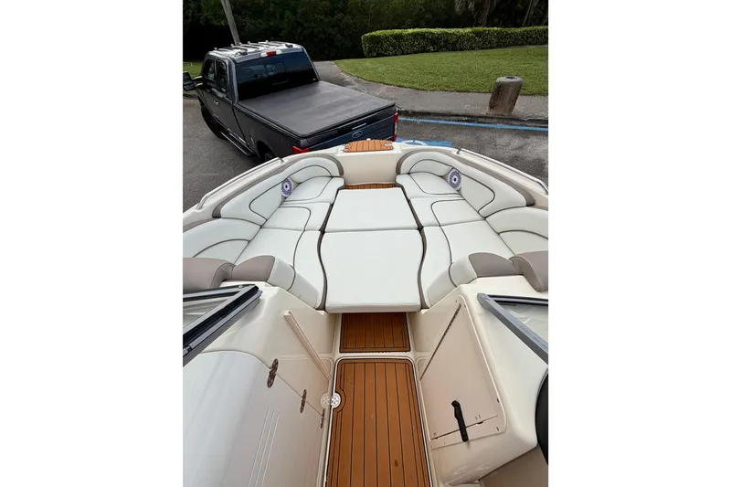 Slide: The Image of 2014 Yamaha Boats 242 Limited interior with plush seating and wood-style flooring. - 22