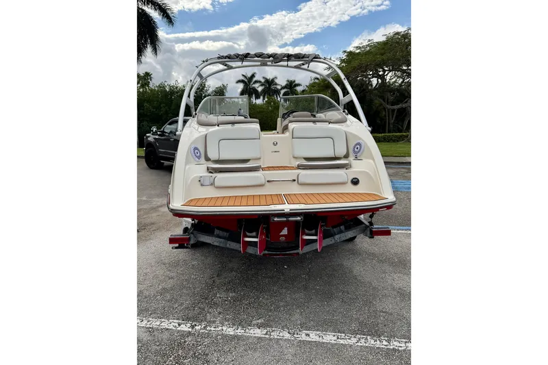 Slide: The Image of 2014 Yamaha Boats 242 Limited, rear view, parked on a trailer in a scenic location. - 27