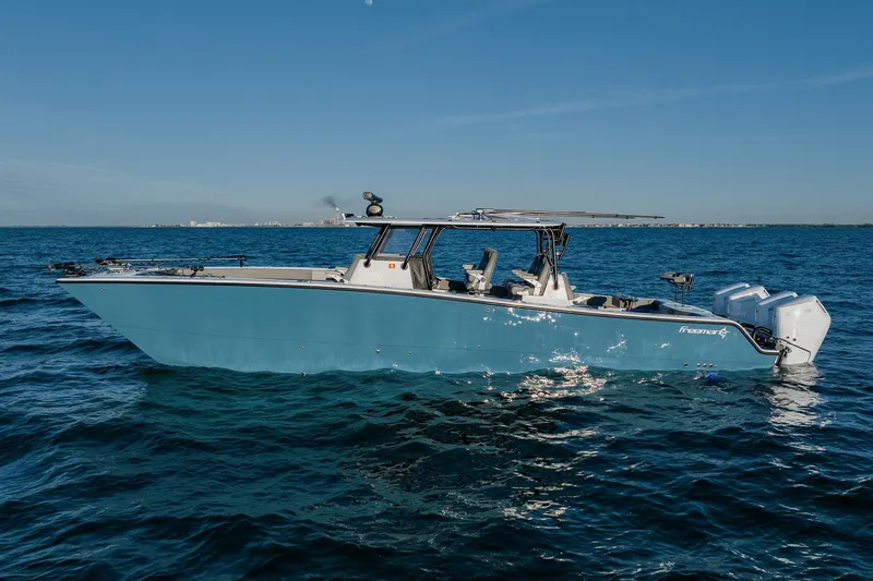 The Image of 2025 Freeman 42LR boat on open water, clear sky, side view. - 0