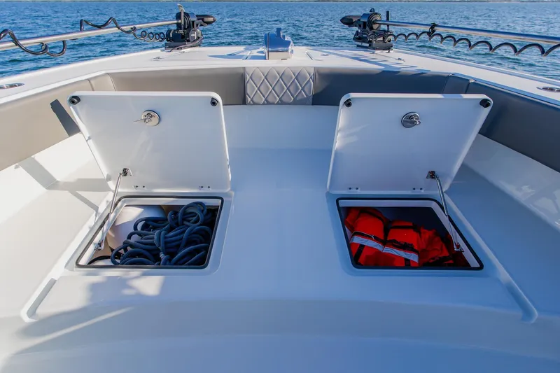 Slide: The Image of Freeman 42LR 2025 boat deck with open storage compartments, ropes, and life jackets. - 10