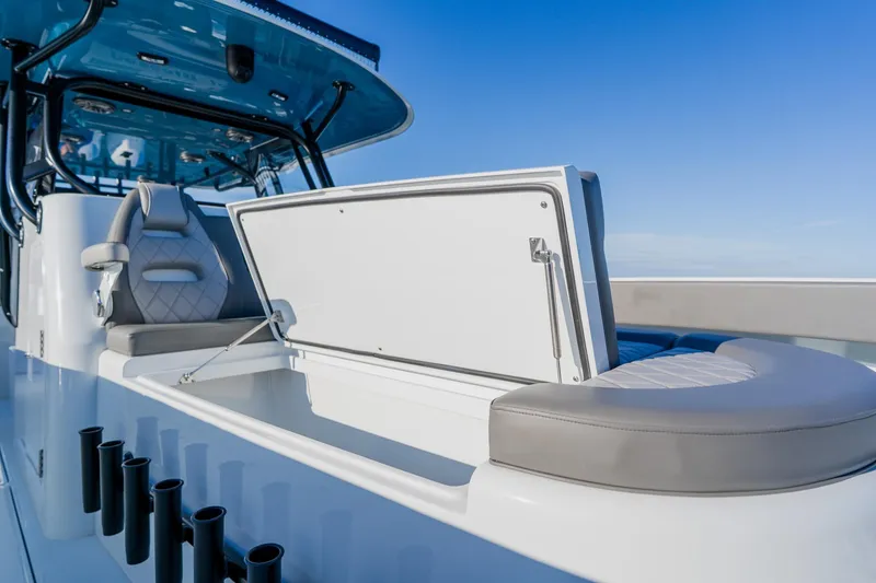 Slide: The Image of 2025 Freeman 42LR boat interior with seating and storage, under clear blue sky. - 12