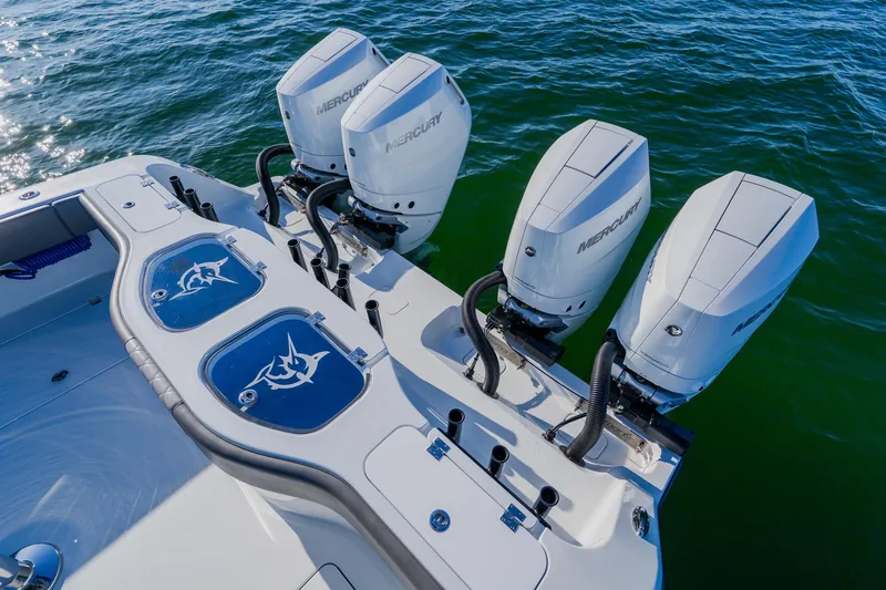 Slide: The Image of 2025 Freeman 42LR boat with four Mercury outboard engines on open water. - 21