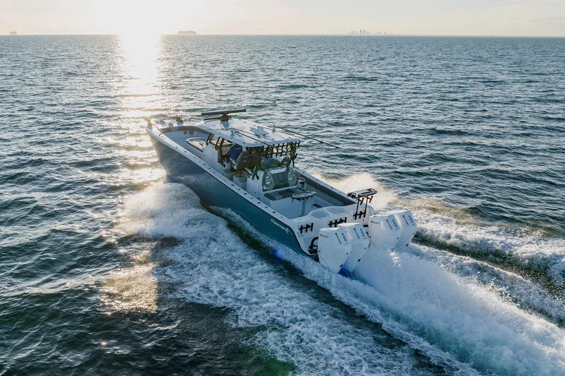 Slide: The Image of 2025 Freeman 42LR boat cruising on open water at sunset. - 4