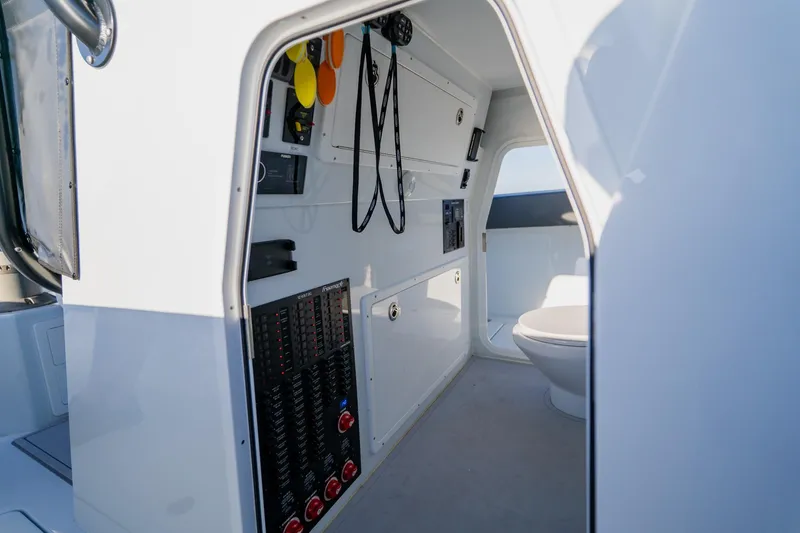 Slide: The Image of Interior of 2025 Freeman 42LR boat showing control panel and compact restroom. - 42