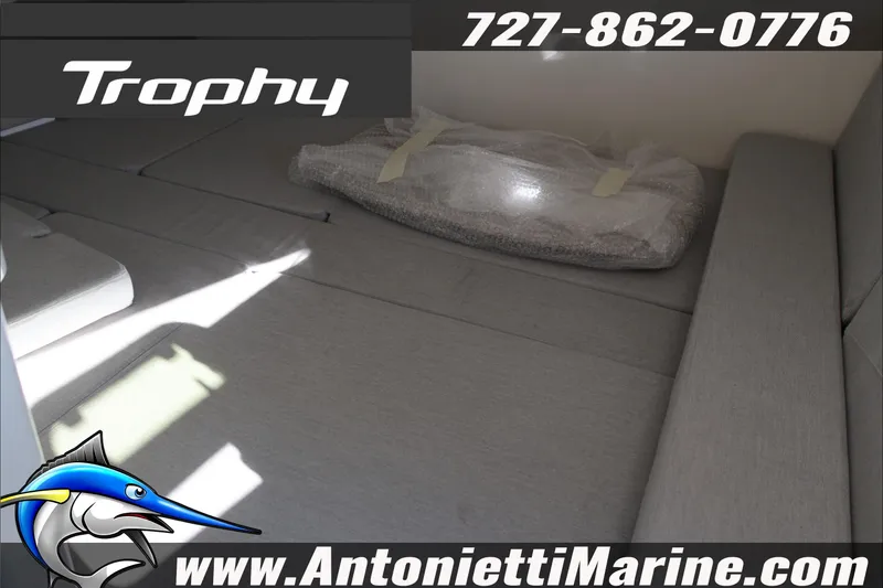 Slide: The Image of 2026 Bayliner Trophy T29 Explorer interior with gray seating, contact details, and logo. - 14