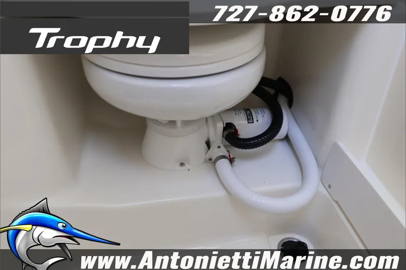 Slide: The Image of Bayliner Trophy T29 Explorer 2026 marine toilet with plumbing, featuring contact details and logo. - 22