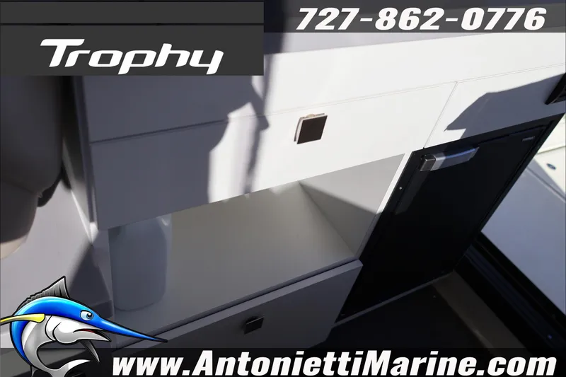 Slide: The Image of 2026 Bayliner Trophy T29 Explorer interior with storage and mini fridge, Antonietti Marine branding. - 24